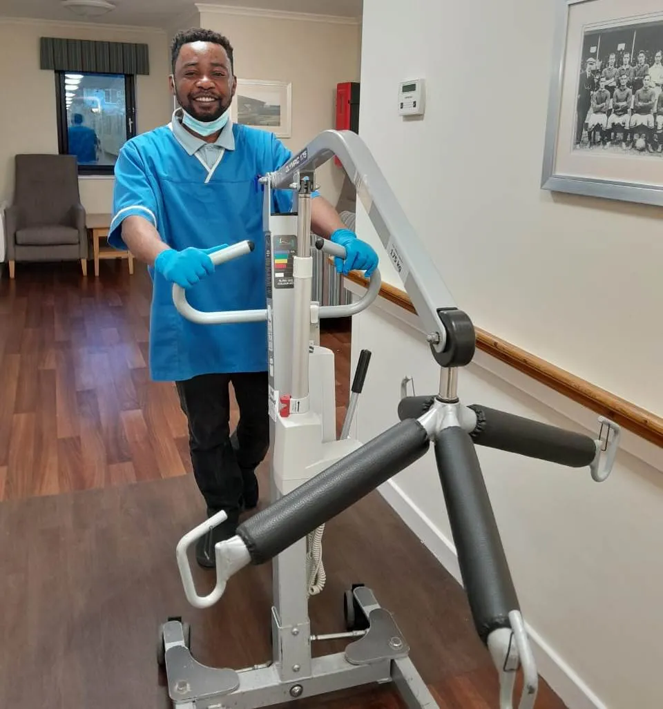 A Blisscare carer preparing mobility equipment