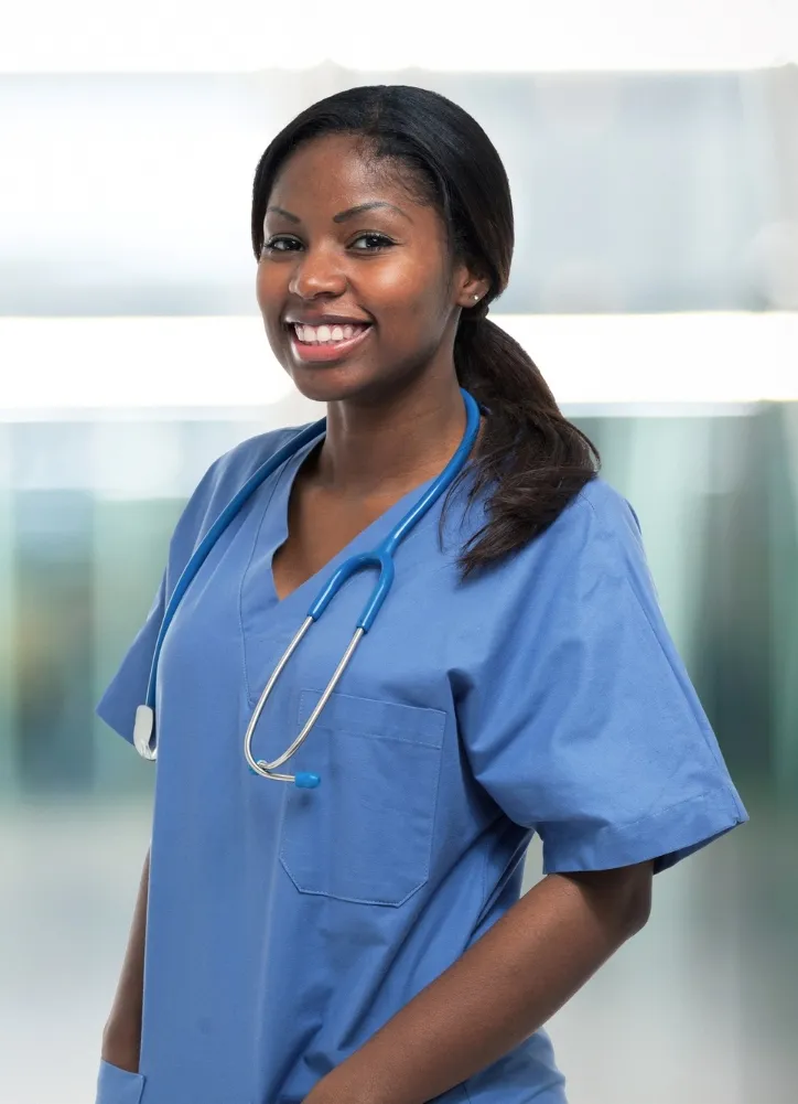 A smiling Blisscare nurse in blue scrubs